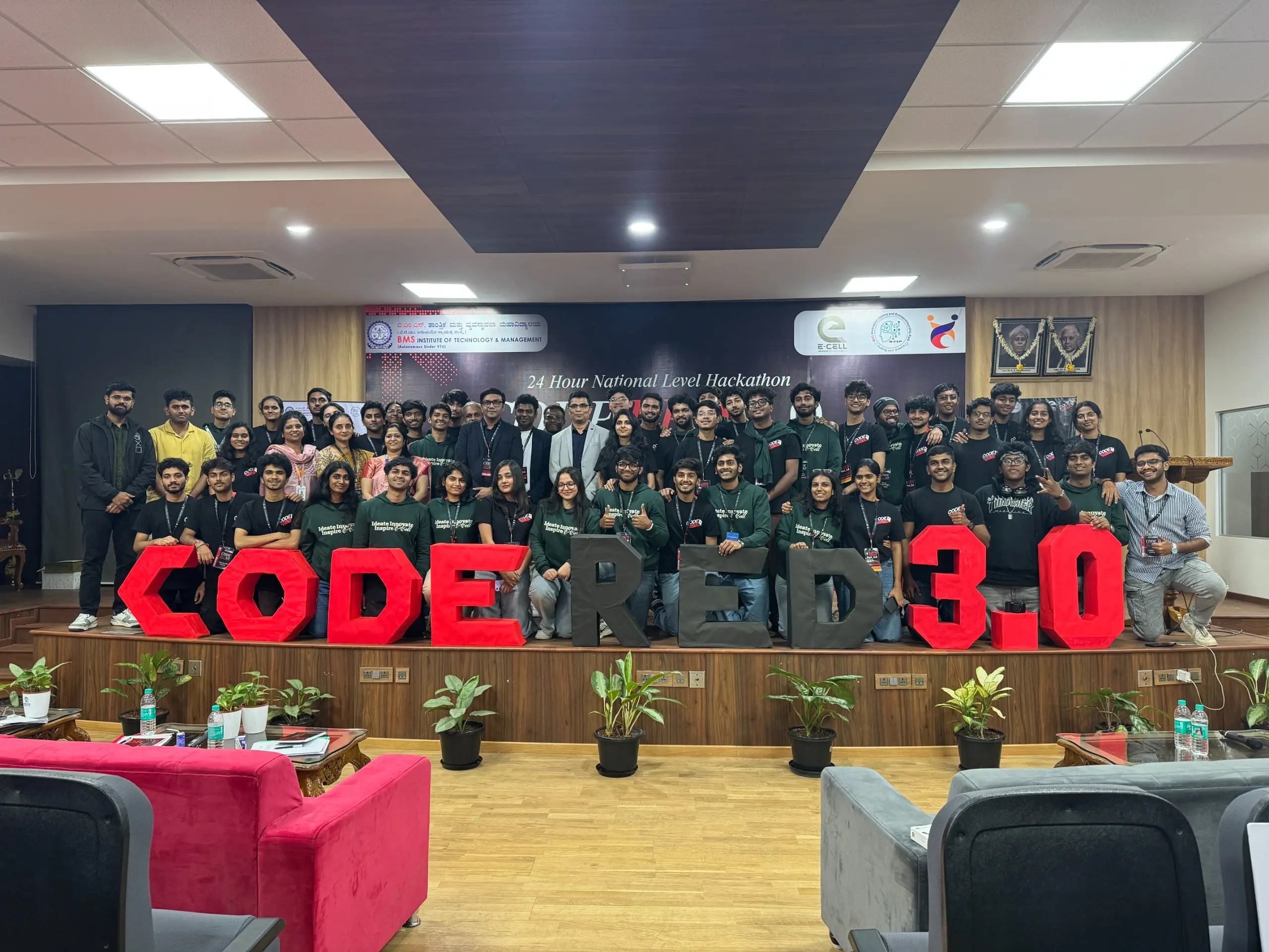 Participants and organizers at a previous Code Red event, standing behind large Code Red letters